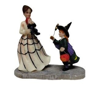 Halloween Figurine: Mother with Children Dressed up in Costumes.